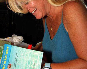 Miles signing her book, "Only in Key West."  In her many books, Miles muses about the ordinary, the bittersweet and the oddly Key West with witty simplicity